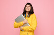 © SHOTPRIME STUDIO - A cheerful student stands against a pink backdrop, hugging a laptop and wearing headphones. This bright, contemporary portrait conveys creativity, study, and positive energy.