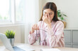 © KMPZZZ - Eye problem concept, fatigue asian young woman tired eyes, irritated rubbing nose, relief vision pain after work on laptop computer, eye strain, hand holding glasses, suffer migraine, bad blurry.