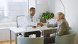 © Monkey Business - Senior Man In Hospital Office Having Consultation With Male Doctor Shaking Hands
