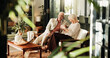 © peopleimages.com - Coffee, laughing and relax with old couple in living room of home together for break or wellness. Drink, funny and love with happy senior people in apartment for bonding, me time or retirement