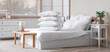 © Pixel-Shot - Cozy bed with white blanket and stack of soft pillows in stylish bedroom