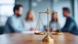 © FramePulse - A golden balance scale on a wooden table with blurred people in the background.