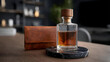 © sornram - Elegant whiskey bottle displayed on a table, showcasing rich amber liquid and a stylish leather case in a sophisticated setting.