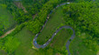 © gunungkawi - Aerial view of winding road in Malang, East Java, Indonesia surrounded by tropical green hills