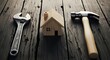 © Omar Studio - Home Repair Tools Arrangement Wrench, Wooden Model, and Hammer on Wood Surface