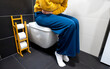 © M-Production - Unrecognizable woman on the toilet with stomach pain.