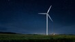© Thares2020 - Wind turbine operates in a field at night under a starry sky