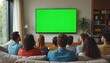 © Vadym - Group of diverse young friends sit on cozy sofa at home. Watching big television with bright green screen. People enjoy sport match, film, show together in modern living room. Friends relax, bond,