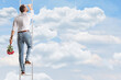 © Ljupco Smokovski - Rear view shot of a man climbing a ladder in the sky