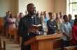 © Vadym - Smiling Black priest gives sermon in church from wooden pulpit. Holds open Bible. Diverse multiethnic congregation stands, listens attentively to pastor. People attend worship service, pray inside