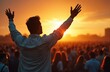 © Vadym - Man raises arms toward sunset sky leading crowd in prayer. People gather outdoors for spiritual event, seeking hope and divine connection. Faith and worship unite community.