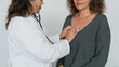 © MarGa - Doctor listening to a patient's heart with a stethoscope. Female physician conducting a medical examination during a routine check-up in a clinic