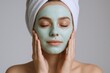 © The Little Hut - Woman with facial mask and wrapped towel, enjoys spa relaxation and skincare treatment, serene beauty