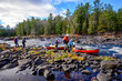 © Michael Connor Photo - Canoe guides lining loaded boats through a shallow rapid on the Madawaska River in fall