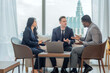 © BESTIMAGE - diverse group business professionals sitting on couch looking tablet. business teamwork brainstorm colleague meeting discussion strategy urban office smart working