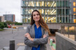 © Miquel - Businesswoman standing confident with arms crossed in city