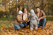 © Pixel-Shot - Happy family with leaves in autumn park