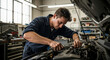 © Sticky Finger - Car mechanic working on car engine in workshop with focused expression