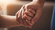 © Margarita Ratatosk - Adult hand holding child hand in close-up. Connection and support between parent and child. Concept of secure attachment, autism, or developmental delay.