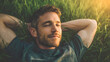 © utaem2022 - Relaxed man enjoying sunshine while lying on grass with peaceful expression and serene atmosphere