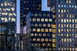 © yaqui_villegas - Modern architecture skyline with glass facade buildings illuminated at night in the Barcode district of Oslo, showcasing urban light reflections and contemporary city design atmosphere