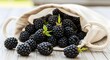 © Nique - Fresh blackberries in reusable eco bag, sustainability concept.