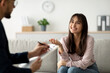 © Prostock-studio - In a comfortable setting, an Arab female client expresses gratitude during her therapy session with a psychologist.