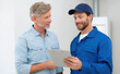 © Jirawatfoto - Professional smiling technician and repairman showing clipboard with maintenance service details to satisfied man and customer about an air conditioner unit