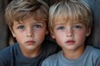 © kardaska - Two young blonde brothers looking directly at viewer