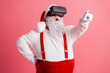 © deagreez - Santa in a VR headset points forward in pink studio wear suspenders white costume festive workshop moment blend tradition and modern holiday