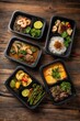 © Aether Pixels - Overhead shot of assorted Thai food in black takeout containers on a rustic wooden table for delivery services