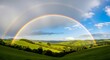 © Farzana Graphics - Double rainbow over green hills landscape background dramatic natural phenomena