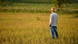 © Stormlab99 - Farmer Standing in a Wheat Field at Sunset Contemplating the Harvest