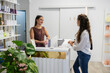 © PintoArt - Friendly receptionist assisting client at modern wellness clinic