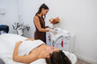 © PintoArt - Aesthetician preparing laser hair removal machine for client