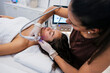 © PintoArt - Woman receiving modern facial treatment for skincare and beauty