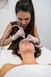 © PintoArt - Woman receiving professional facial skin treatment at spa