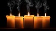 © Prime - Five thick lit candles with wisps of smoke rising against a dark background creating a somber and atmospheric mood