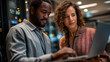© Kateryna - Faceless male cloud architect and female database engineer defocused data center background reviewing storage protocols on laptop team strategizing service improvement