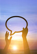 © souayang - Silhouette hands holding speech bubble at sunset, freedom of expression concept