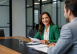 © DAYA-DAKSH - Business meeting in a modern office with smiling woman and man.