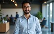 © Sharon - Head shot portrait of happy Indian businessman, company head or executive manager dressed in casual shirt posing for camera standing alone in modern workplace, profile picture. Professionalism, career