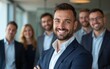 © Sharon - Young smiling businessman standing in front of team, smiling at camera. Created with Generative AI technology. High quality