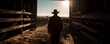 © Rifqi - Silhouette of a cowboy standing in a barn doorway overlooking a herd of cattle at dawn, concept for ranching lifestyle, rural industry and livestock management