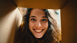© Naufal - Happy young woman looking inside a cardboard box with surprise and joy, concept of delivery, moving, online shopping, unboxing, new beginnings, lifestyle and positive emotions.