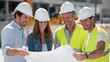 © abc123man - Professional construction team collaborating on blueprints at a busy outdoor site with safety gear, modern infrastructure planning, and teamwork in industry