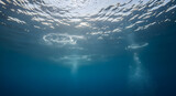 a view from inside of water of sun, life under water, under water sun light, bubbles inside water,