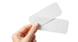 © Digital - Hand holding two blank white paper tickets with perforated edges isolated on a transparent background