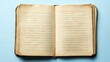 © DnQajik - An open vintage book with aged yellowed pages on a light blue surface