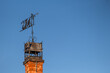 © Сергей Лаврищев - A weather vane on a brick chimney on the roof of a house.